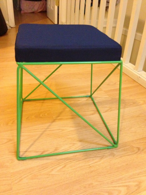 Lime green stool with a navy cushion.