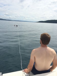 Drew looks on as Eric (in the water) helps Jess get ready